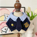 Closeup of officer-style pet bib collar with gold-tone button and badge charm