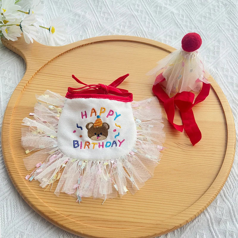 Flat-lay of red birthday bib and matching pom-pom hat