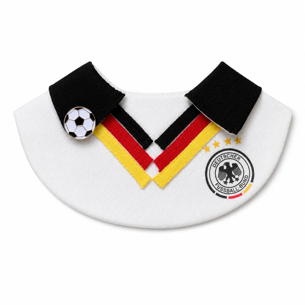 Flat-lay of the white, black, red, and yellow soccer-inspired pet bib with football charm