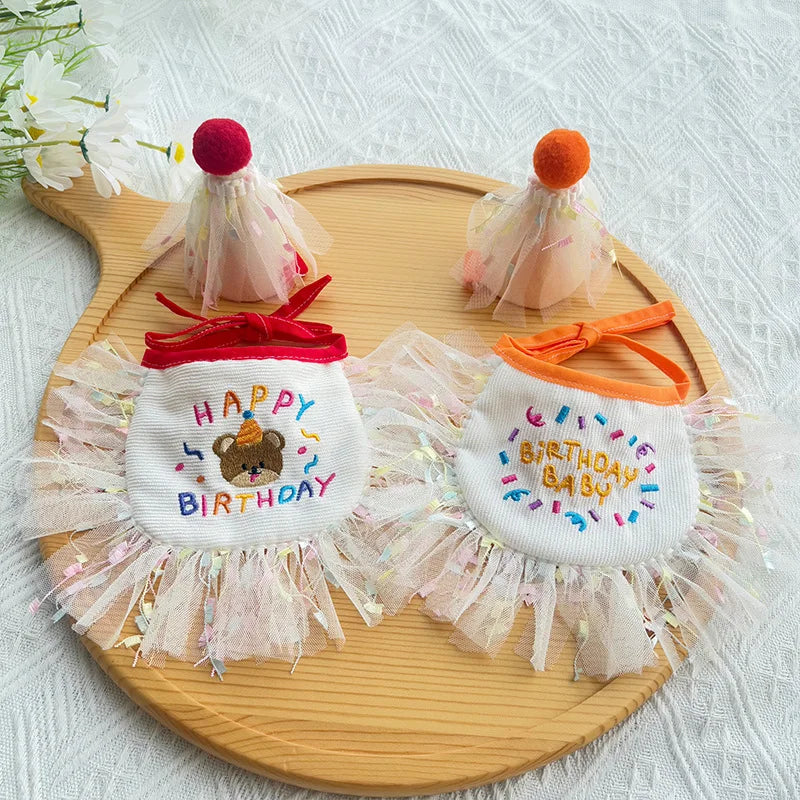 Red and orange birthday bibs and hats flat-lay on a wooden tray